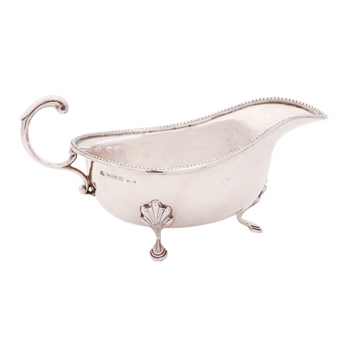 167 - A George VI silver sauce boat, with beaded rim, on hoof feet, 16.3cm l, by Elkington & Co Ltd, B... 