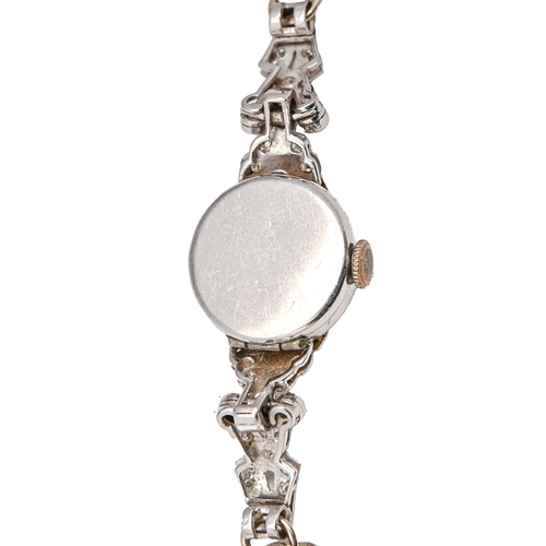 18 - A diamond cocktail watch, c1940, with articulated lugs, in platinum, 1.8 x 6cm, on expanding bracele... 