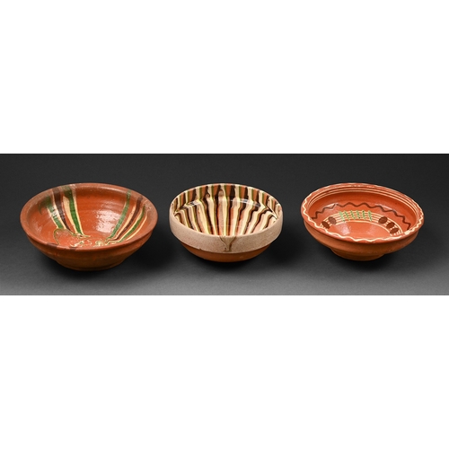 279 - Three terracotta slipware bowls, early 19th c and later, 18cm diam and smaller