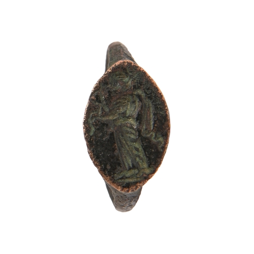 45 - Classical antiquities. A Grecian bronze intaglio ring, 4th c BC, engraved with Nike with garland, si... 
