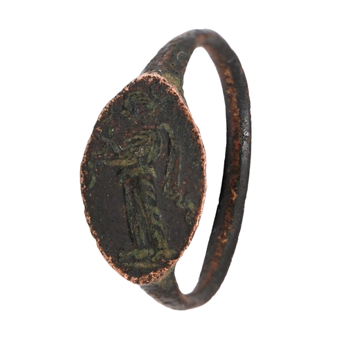 45 - Classical antiquities. A Grecian bronze intaglio ring, 4th c BC, engraved with Nike with garland, si... 