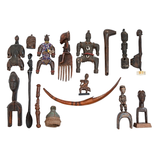 556 - Tribal art. Seventeen West and Central African carved wood objects, 19th/20th c, including slingshot... 