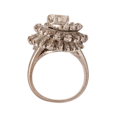 31 - A diamond ring, with tiered cluster of round and baguette diamonds, in white gold coloured metal, in... 