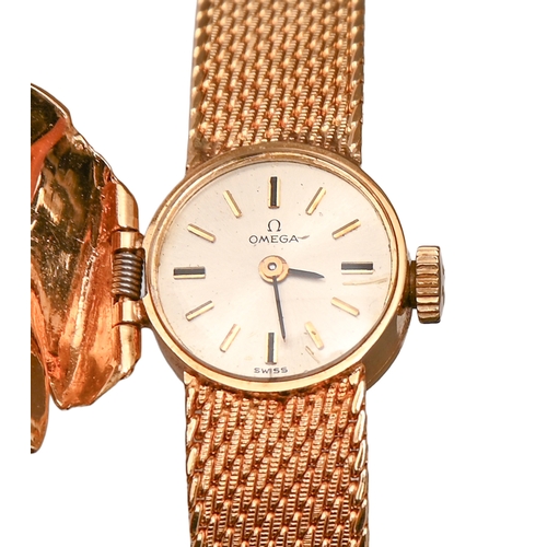 547 - An Omega diamond palm leaf-enclosed lady's wristwatch, in gold, 1.4cm diam, marked 14K, on maker's g... 