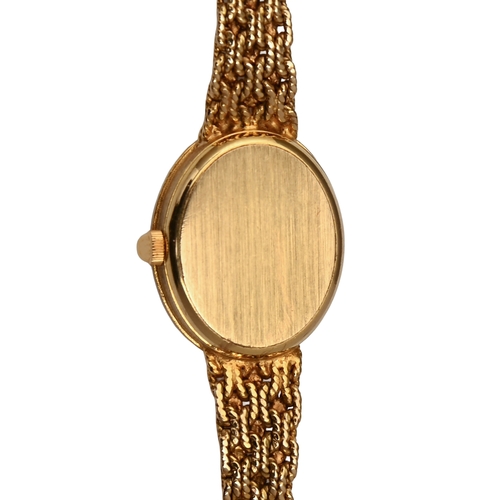 550 - A Bueche-Girod 9ct gold oval cocktail watch, with diamond bezel, 2cm, on maker's tapering textured g... 
