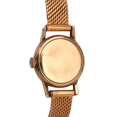 551 - An Omega 9ct gold lady's wristwatch, 1.9cm diam, Birmingham 1964, on associated gold tapering textur... 