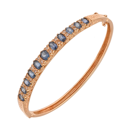 561 - A sapphire and diamond bangle in Victorian style, in 9ct gold, 5.8cm (internal), Convention marked, ... 