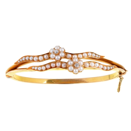 63 - An Edwardian diamond and split pearl bangle, in gold, 5.6cm (internal), marked 15ct, 17.4g... 