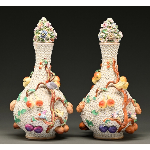 79 - A pair of German porcelain floral encrusted vases and covers, early 20th c, decorated in the Meissen... 