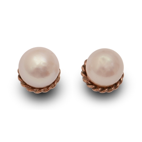 31 - A pair of single cultured pearl ear studs, in 9ct gold, 0.6cm diam, marks obscured, 1.3g... 