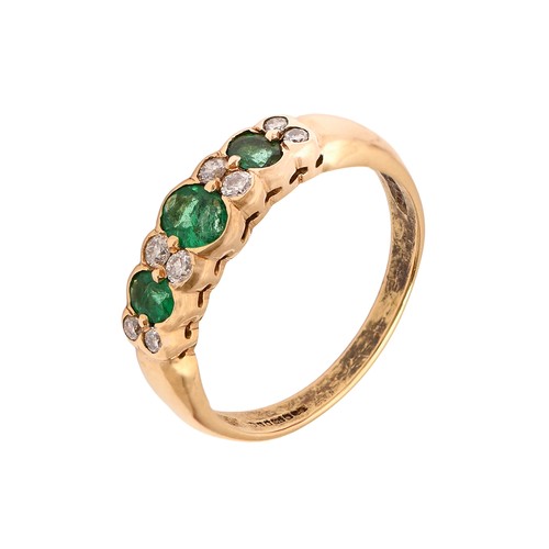 11 - An emerald and diamond ring, the three larger emeralds divided by eight smaller diamonds in pairs, i... 