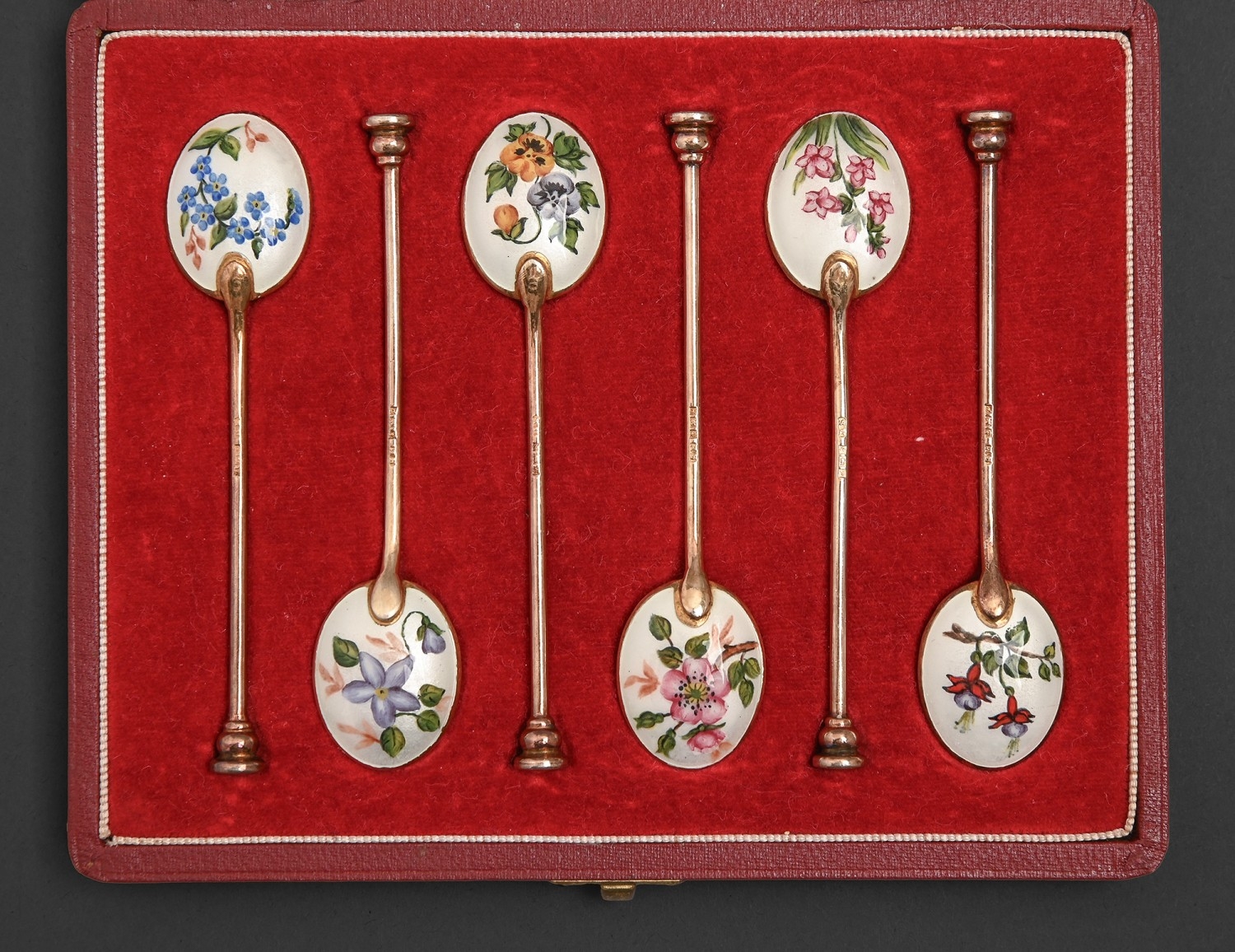 A set of six silver gilt and enamel seal terminal coffee spoons, with ...