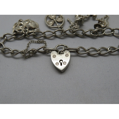 121 - Vintage silver charm bracelet with 7x charms Birmingham 1966 22g