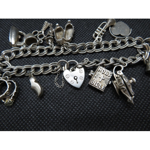 184 - Vintage silver charm bracelet with 13 charms Shefflied 1974