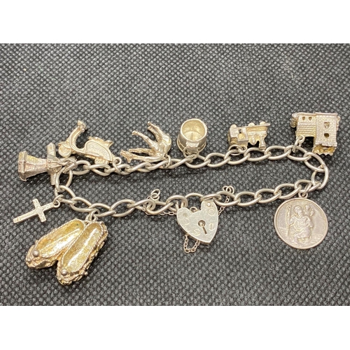 34 - Vintage silver charm bracelet 9x charms Birmingham 1977 33g