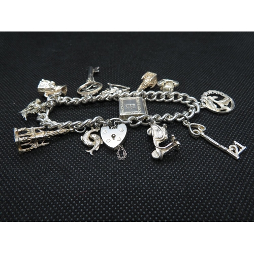 67 - Vintage silver charm bracelet with 12x charms every link HM Lion Passant and full HM padlock Birming... 