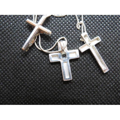 73 - Silver diamond set cross and chain Mother of Pearl and blue topaz cross and chain and silver crucifi... 