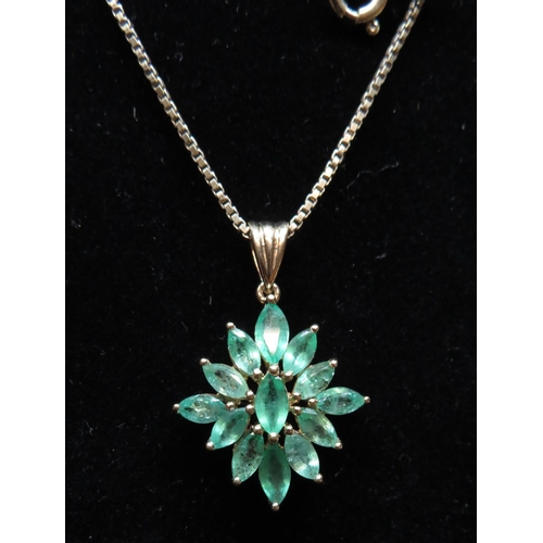 82 - Gold on silver starburst pendant set with emeralds on 18