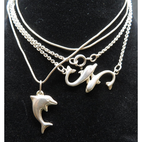 15 - 2 vintage silver dolphin pendants on 16