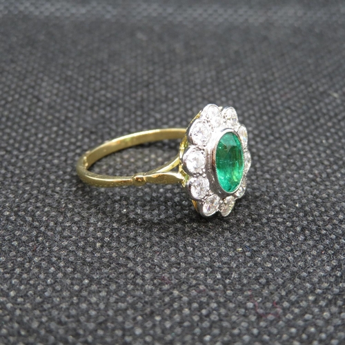 7 - 18ct gold and platinum cluster ring with central oval emerald approx 1.2ct with 10 natural brilliant... 