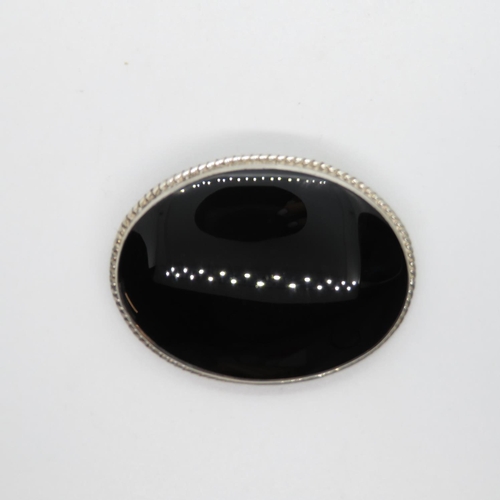 31 - Silver brooch set with large oval black onyx stone Sheffield 1994 13.9g