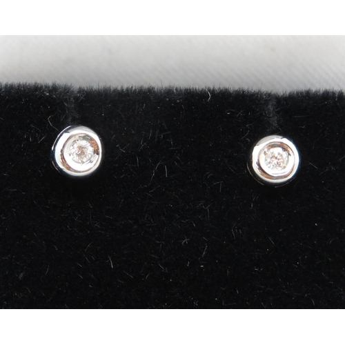 57 - Pair of 9ct white gold and diamond earrings