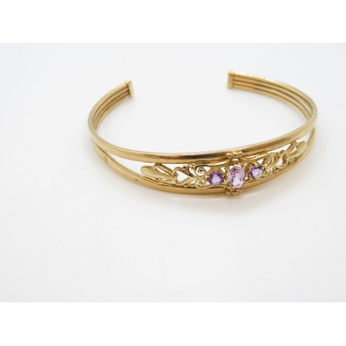 15 - Early 9ct gold bangle with purple stones 6.3g