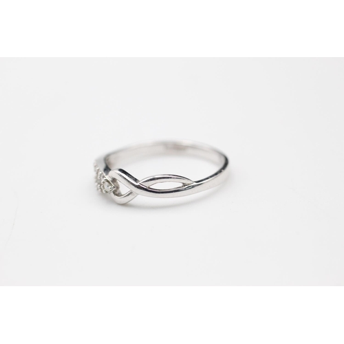 149 - 9ct white gold diamond twist ring size N