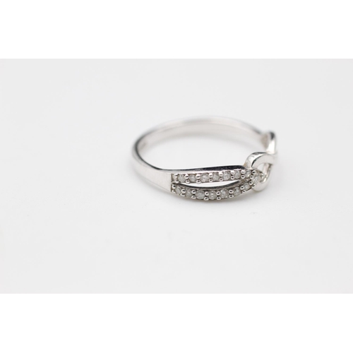 149 - 9ct white gold diamond twist ring size N