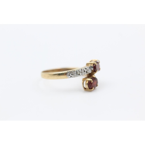 226 - 9ct gold garnet & diamond bypass design ring size P