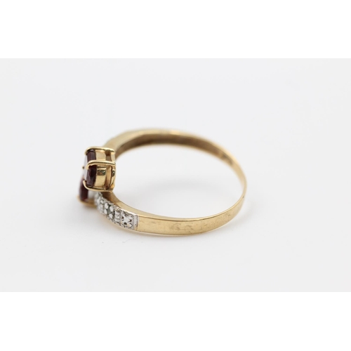 226 - 9ct gold garnet & diamond bypass design ring size P