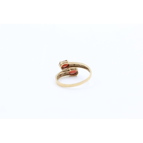 226 - 9ct gold garnet & diamond bypass design ring size P