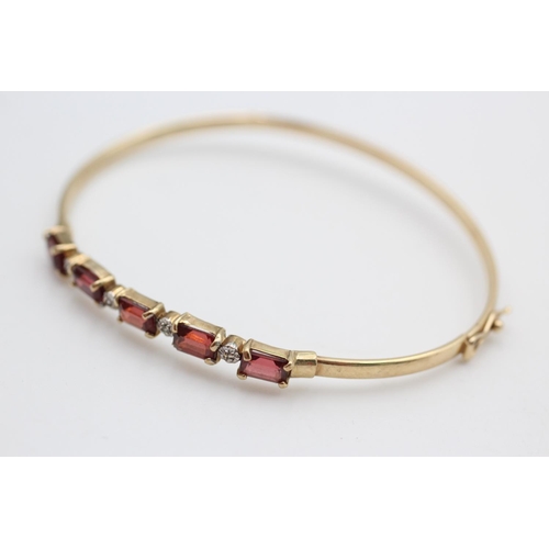 232 - 9ct diamond and garnet bangle