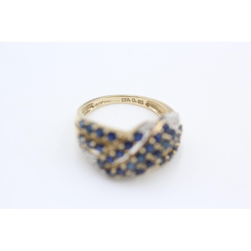 253 - 9ct gold sapphire and diamond cross over ring size N