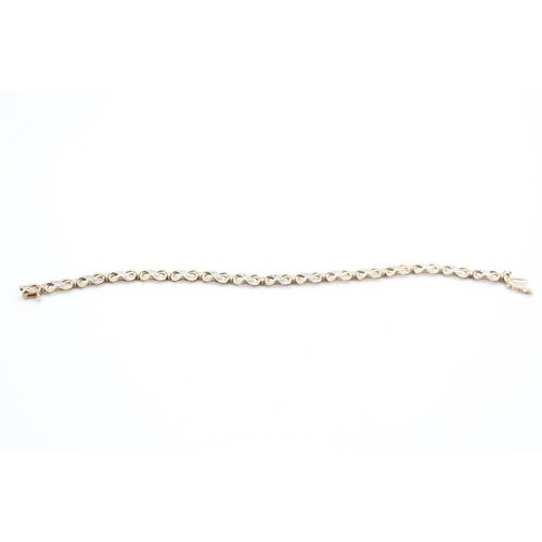 257 - 9ct gold diamond figure of eight bracelet