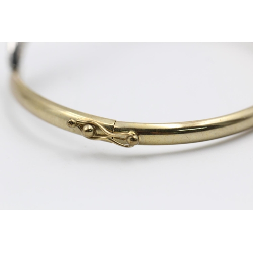 263 - 9ct gold gemstone petal twist flexible bangle