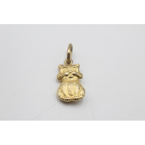 46 - 2 x 9ct gold vintage charm pendants inc. cat & theatre masks (2.1g)