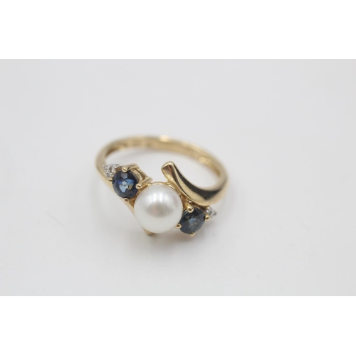 64 - 9ct gold diamond, sapphire & pearl bypass style ring (2.4g)