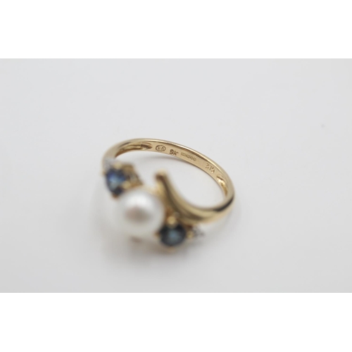 64 - 9ct gold diamond, sapphire & pearl bypass style ring (2.4g)