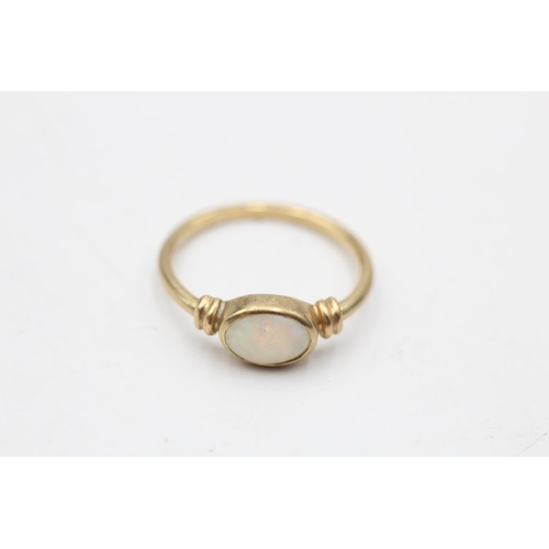 48 - 9ct gold opal ring with rub over setting. (1.4g) Size K