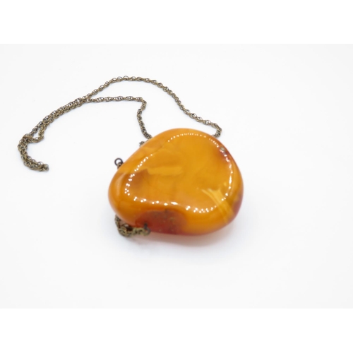 26 - Large lump of amber - butterscotch colour - on chain 39g