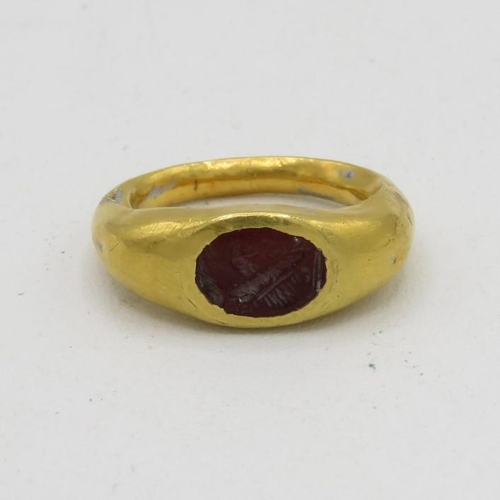 6 - Roman gold ring child's size with engraved Intaglio probably garnet 1.7g