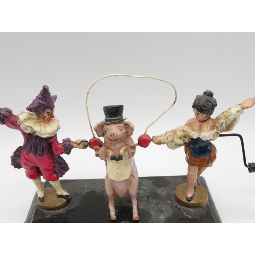 90 - Articulated pig in top hat with bow tie skipping on rope with two ladies holding rope in cast metal ... 