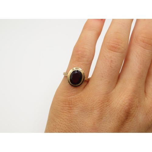 109 - 9ct gold and garnet ring size J 2.5g