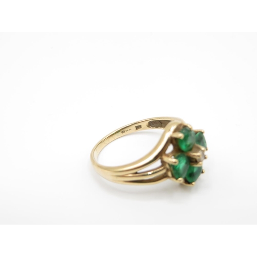 157 - 9ct gold ring with green stones size P  3.6g