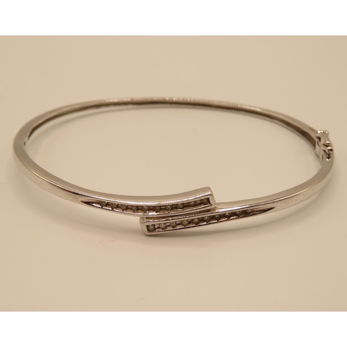 62 - 9ct white gold bangle with diamond chippings 6.8g