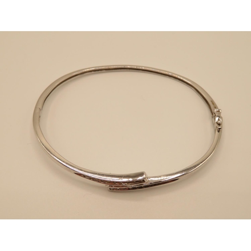 62 - 9ct white gold bangle with diamond chippings 6.8g