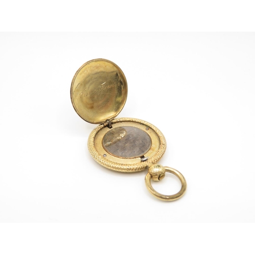 67 - 9ct gold locket containing plaited hair with spring opening catch 30mm diameter  9g