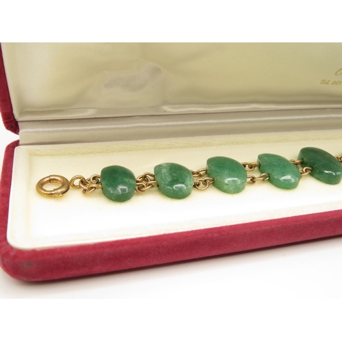 77 - 9ct gold and green stone bracelet 21cm long  27.4g