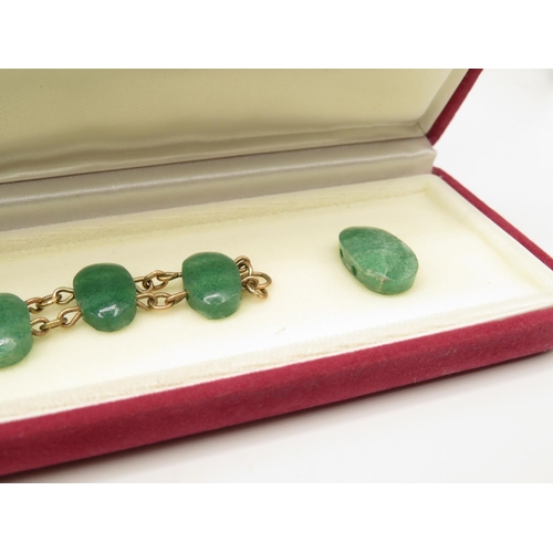 77 - 9ct gold and green stone bracelet 21cm long  27.4g